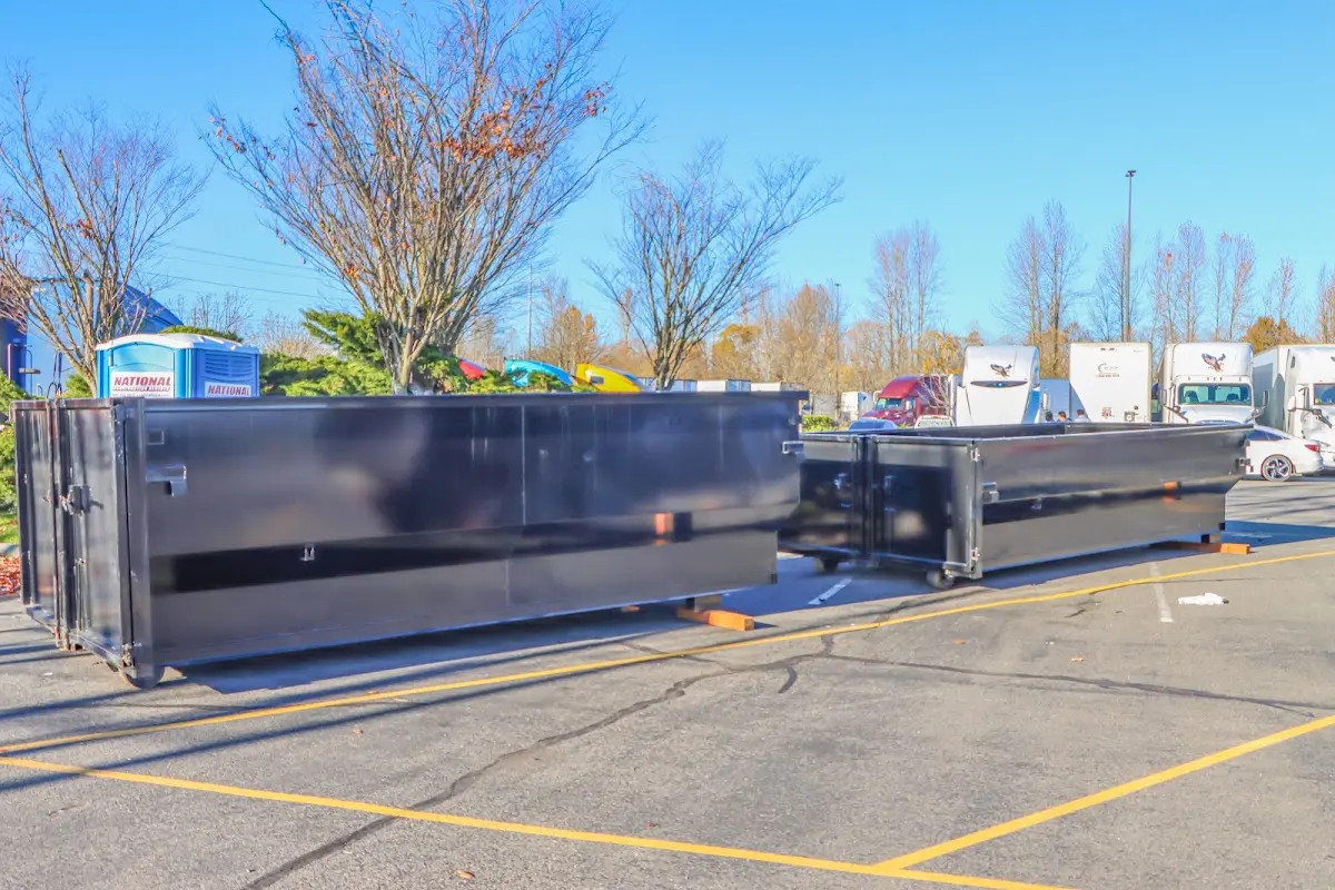 Professional dumpster rental service with roll-off container on residential driveway in Porter